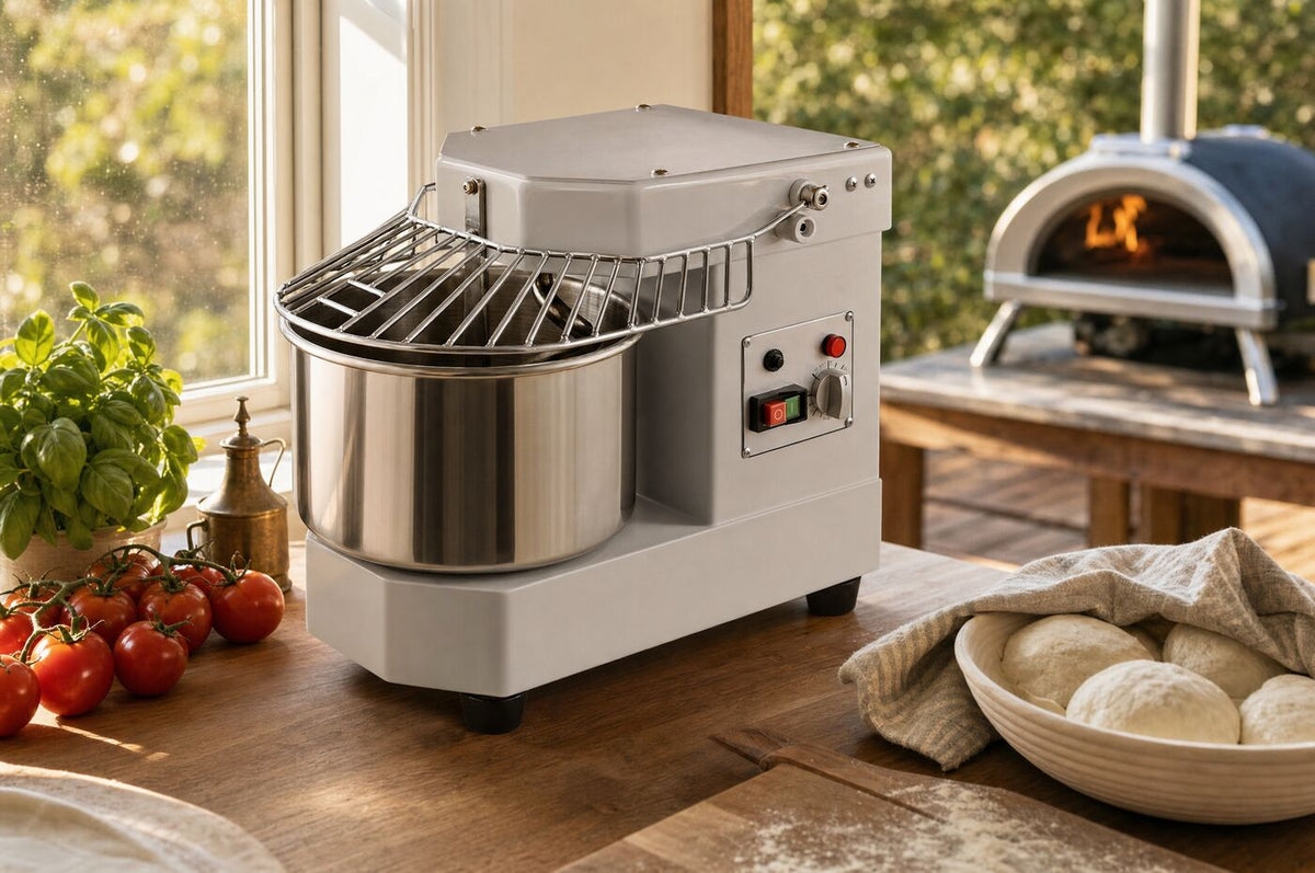 The mixer on a home kitchen bench with dough balls proofing beside it