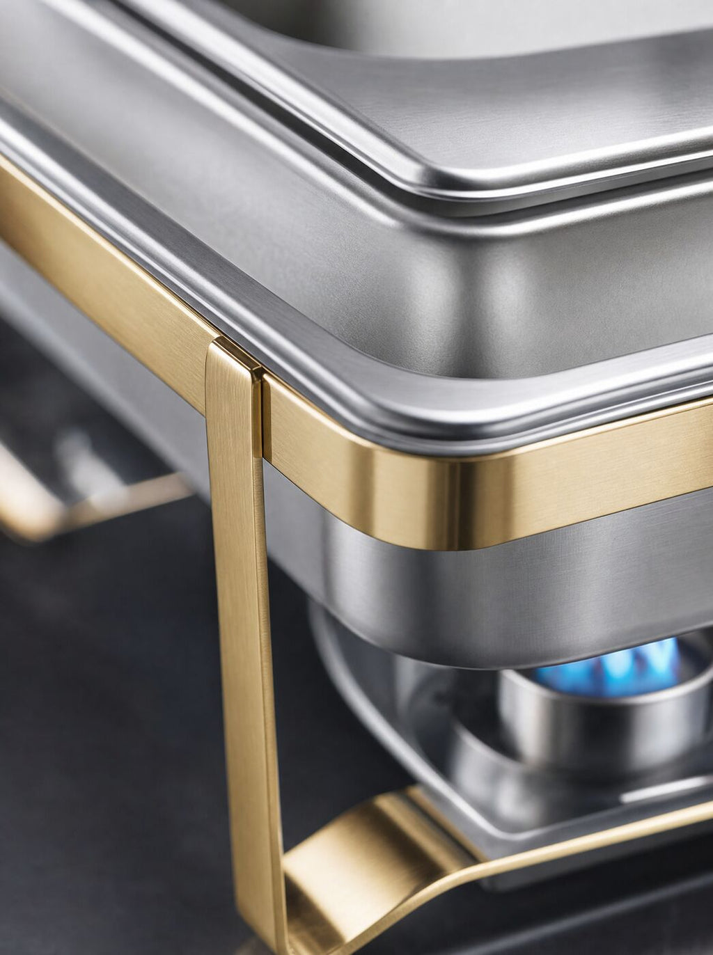Close view of the gold frame, water pan lip and fuel flame
