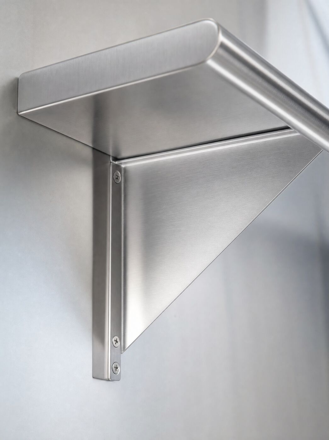 Close view of a welded bracket under the shelf