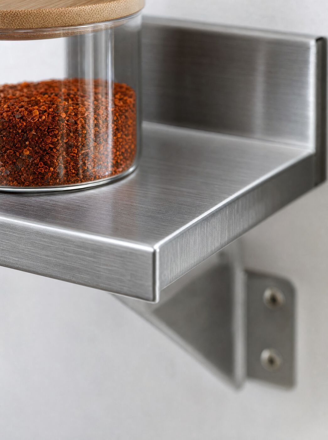 Close view of the front lip and bracket of the shelf